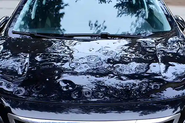 Hail-damaged bonnet before repair